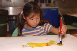 young girl painting a picture