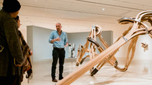 tour group in a room full of sculptures