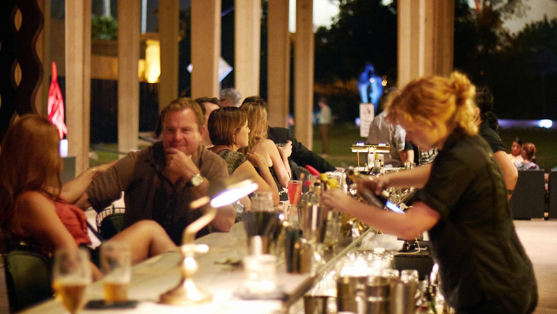 people sitting at bar in museum courtyard