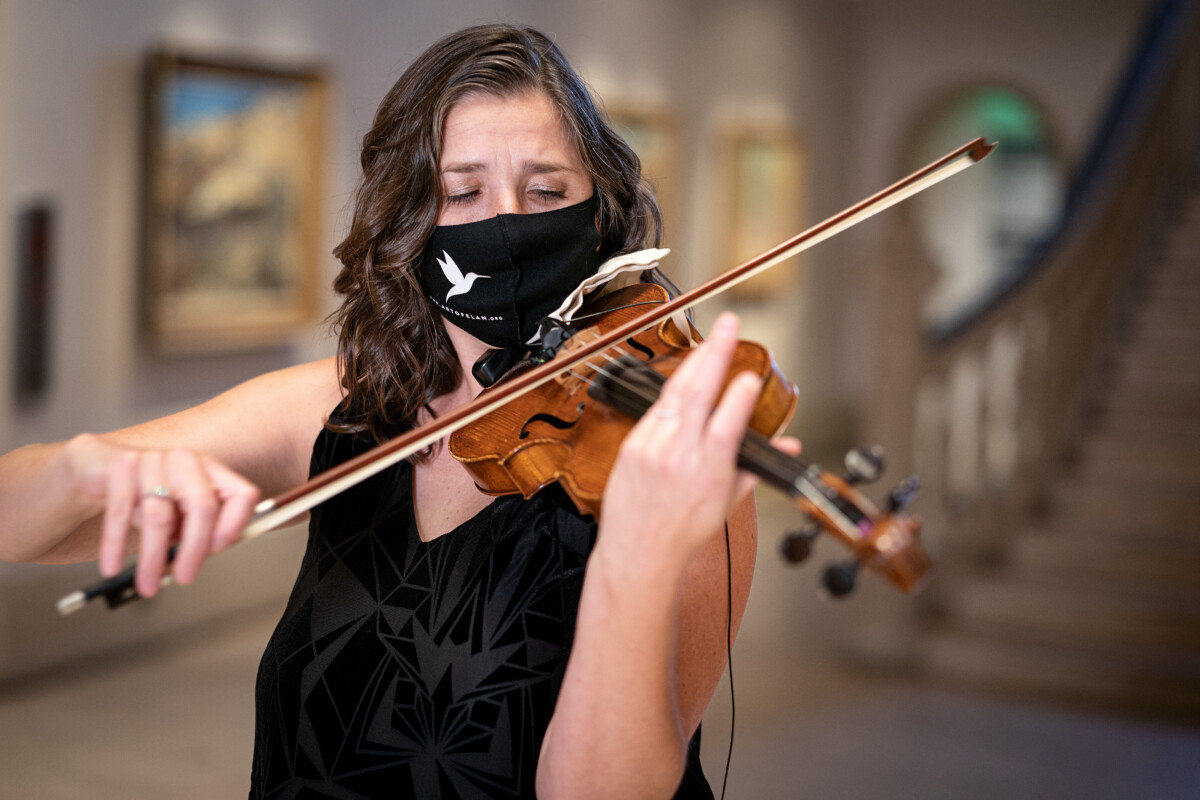 Art of Elan - Picture of Kate Hatmaker, Art of Elan Executive and Artistic Director, performing on violin in The San Diego Museum of Art rotunda. Photo by Gary Payne. Courtesy of Art of Elan.