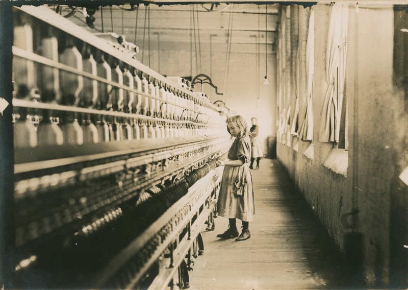 Girl working in factory sepia photograph