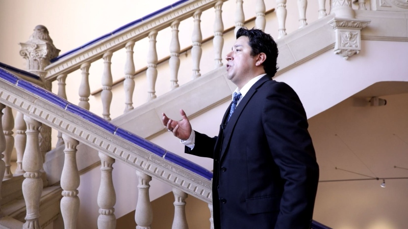 Man walking up staircase and singing