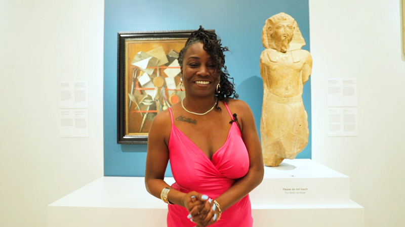 Woman in art museum with Egyptian Ramesses II sculpture