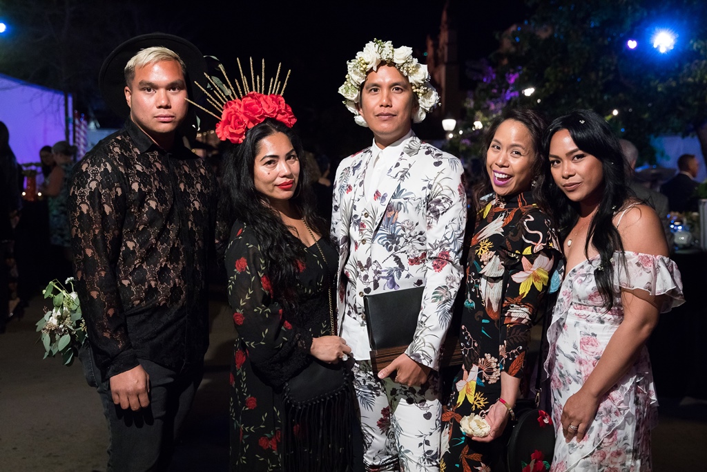 Five people in floral attire at night