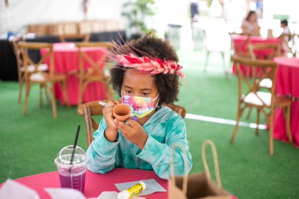 Girl decorating pot at The San Diego Museum of Art's 2021 Art Alive Garden of Activities