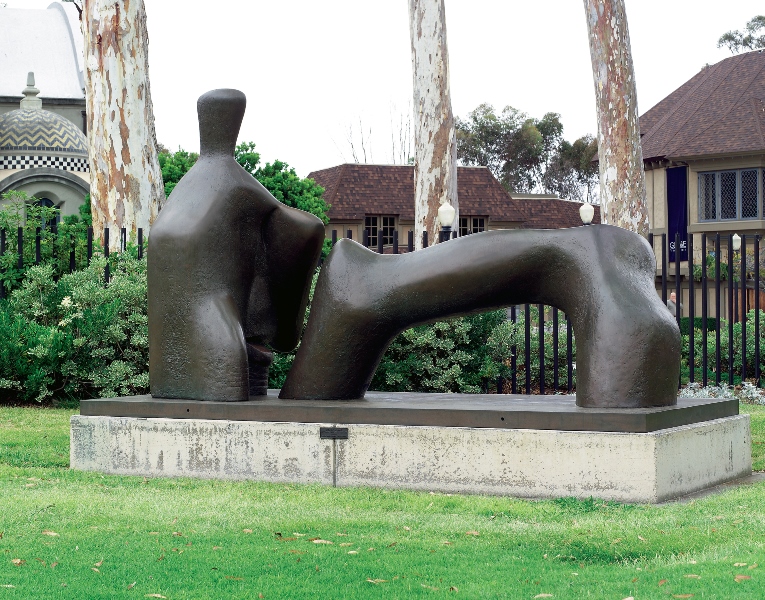 Reclining Figure Arch Leg bronze sculpture by Henry Moore in outdoor garden