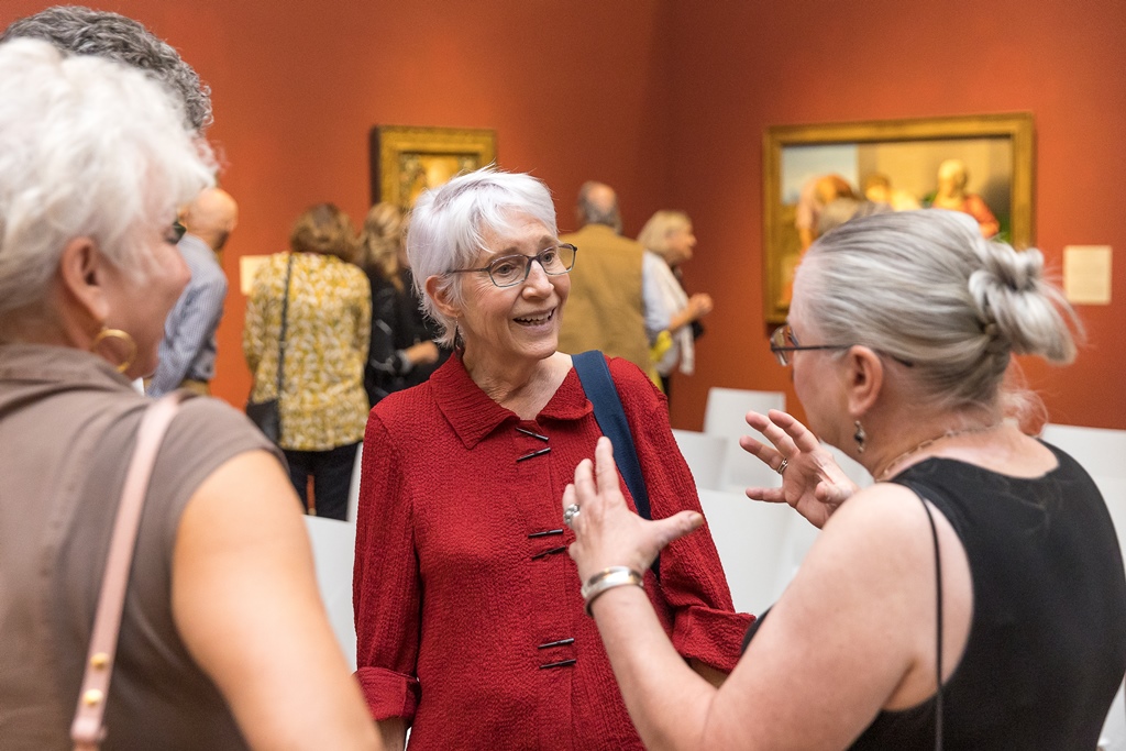 People talking in museum gallery