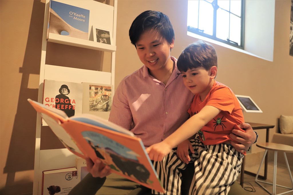 Man and child reading a book