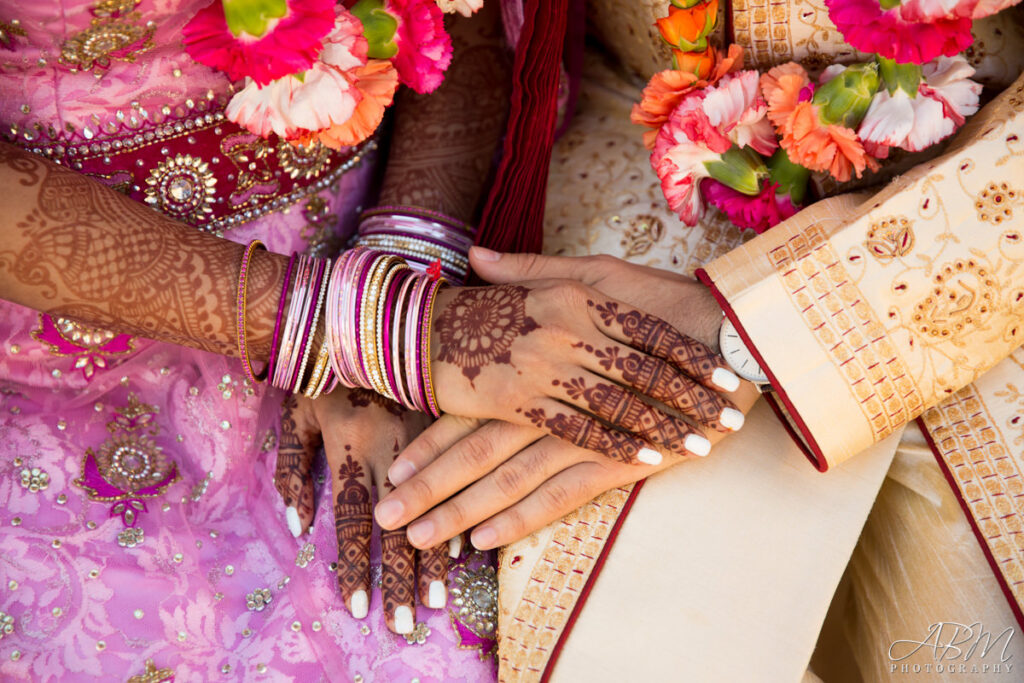 bridal couple's hands with mehndi henna on hands and arms