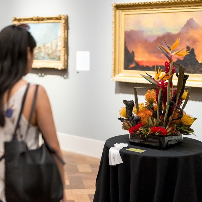 Woman looking at Art Alive floral interpretation