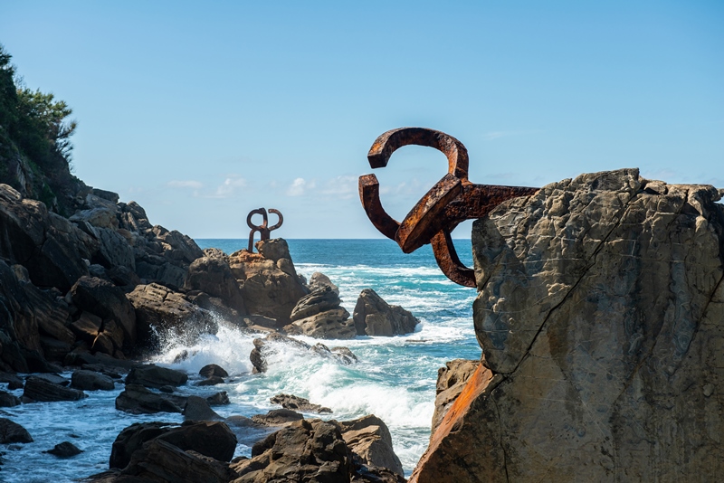 Sculptures in rocky cliff by ocean