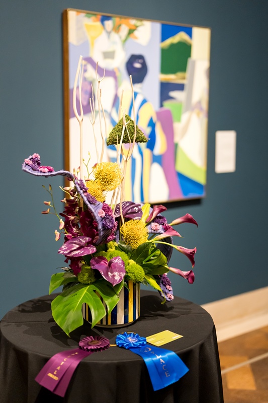 Art Alive floral arrangement on table interpreting painting on wall
