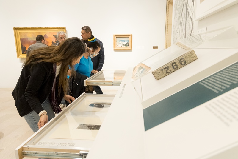 People looking in Visible Vaults drawers