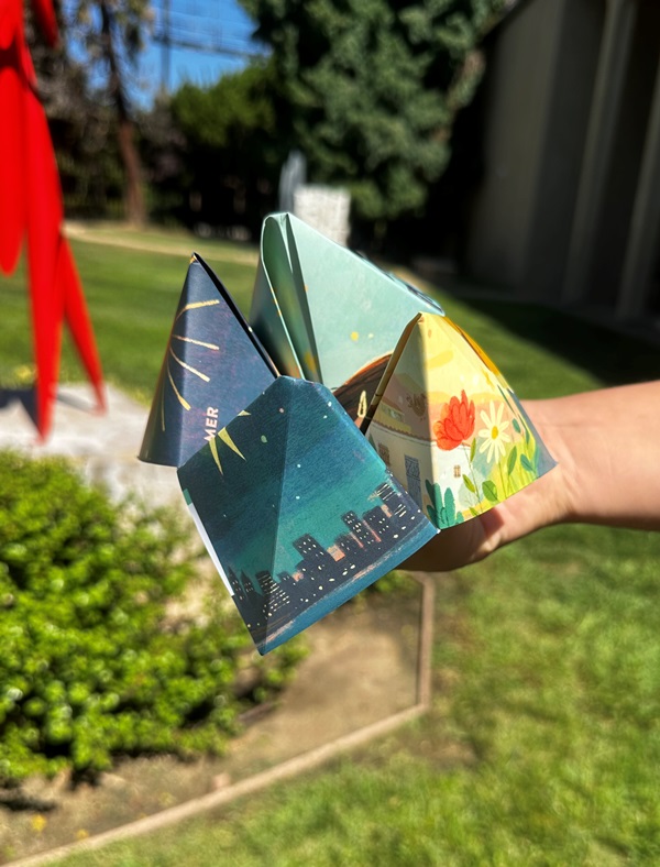 Hand holding fortune teller origami
