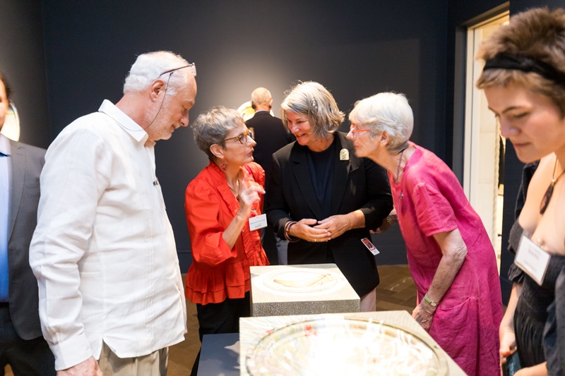 People talking in art gallery