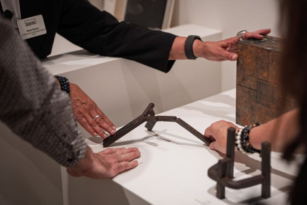 Hands touching art objects and sculptures