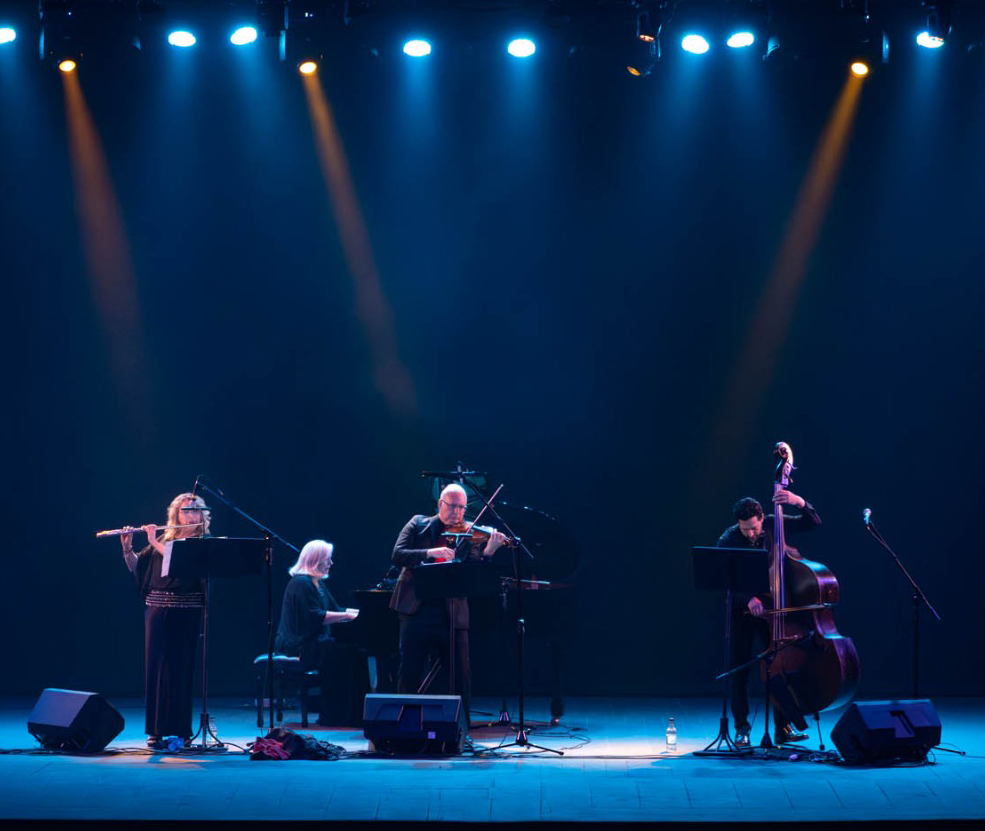 The Camarada Tango Quartet performing on stage with dramatic lighting